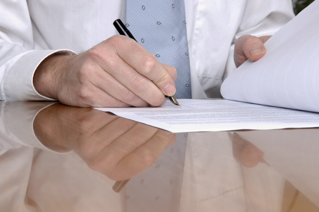 Picture of people signing a contract